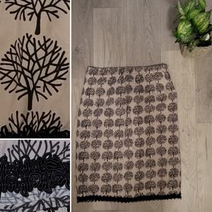 Black and tan knee-length skirt with lace trim and tree design